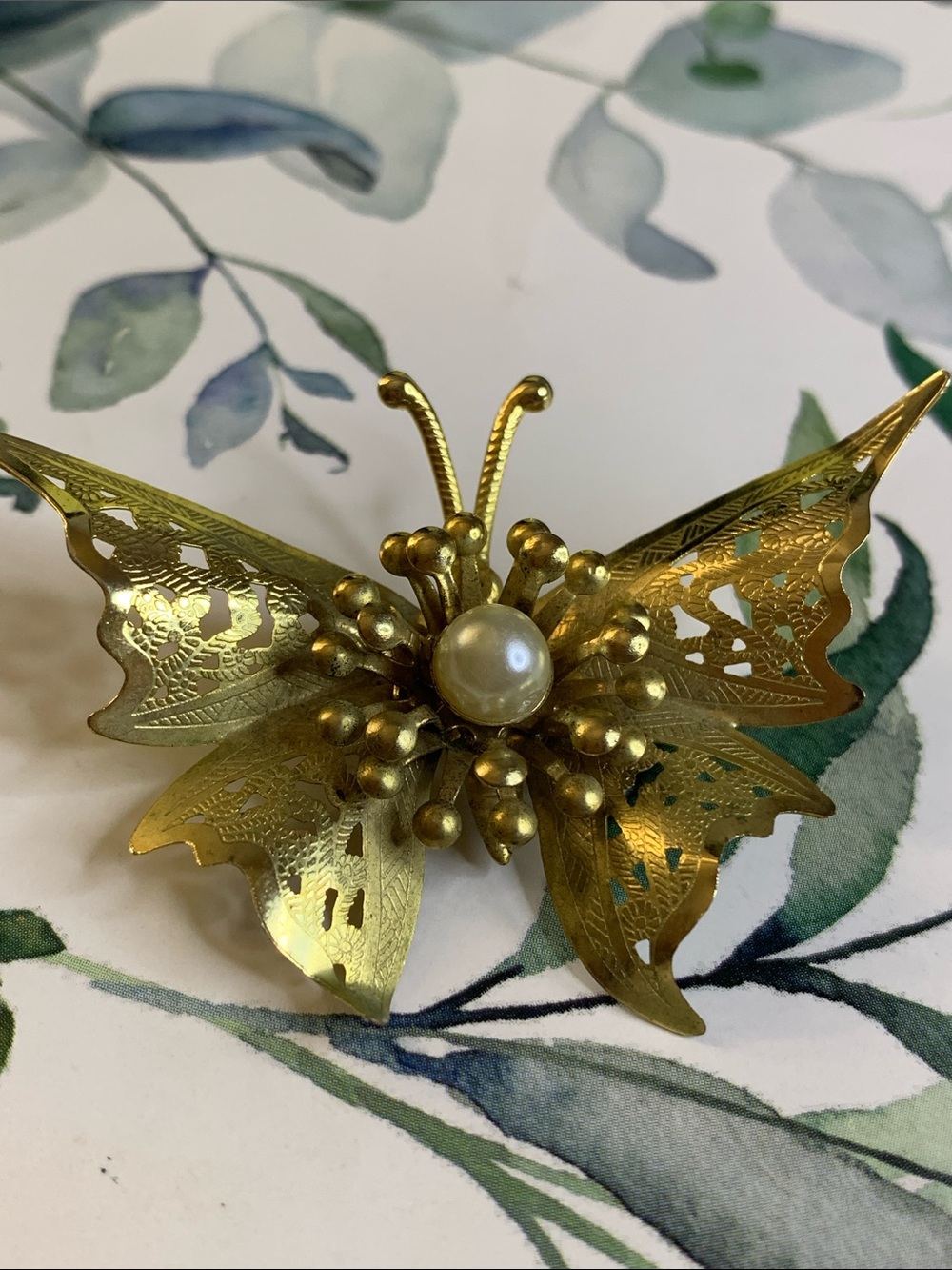 Delicate Butterfly with Filigree Goldtone Wings and Faux Pearl